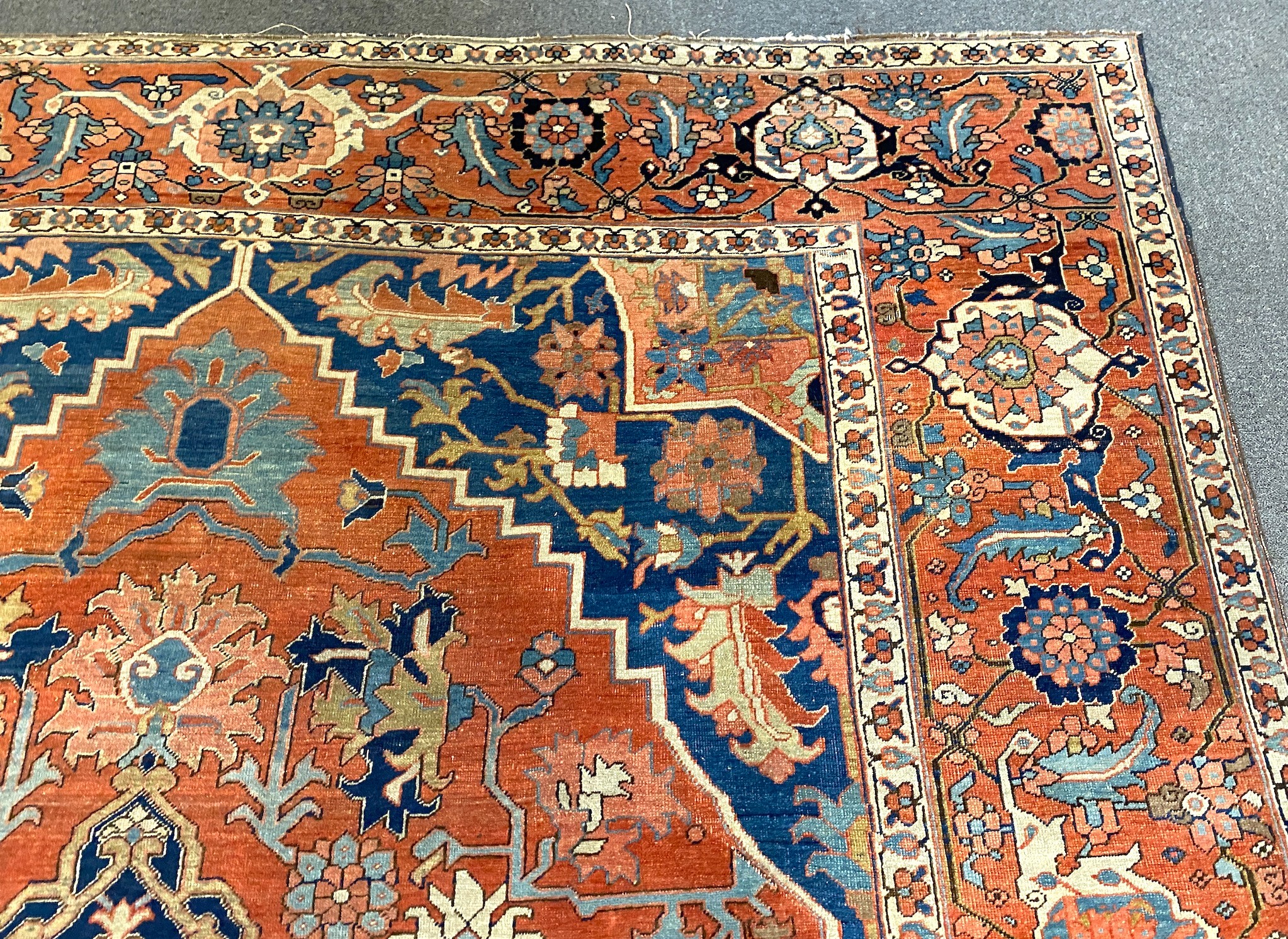 An antique Heriz brick red ground carpet, 370cm x 290cm